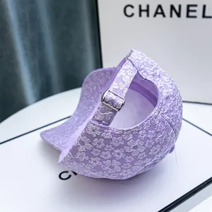 Detailed close-up of light purple floral baseball cap with metal adjustable buckle