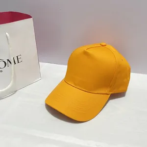 Close-up of bright yellow five-panel baseball cap with reinforced stitching on the brim
