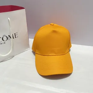 Close-up of bright orange cotton baseball cap with five rows of stitching on the brim