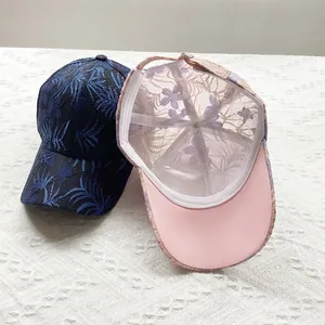 Detailed view of floral lace embroidery and mesh texture on women's baseball caps