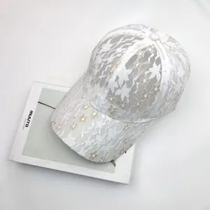 Elegant white lace baseball cap with floral embroidery and breathable mesh sun protection