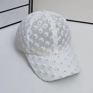 Detailed macro view of white lace mesh baseball cap with 3D floral pearls embellishment