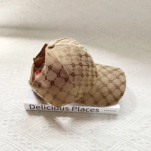 Detail view of khaki jacquard sun hat with letter R patterns and back opening for high ponytail
