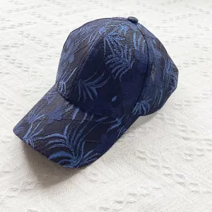 Close-up of dark blue lace floral pattern and breathable mesh on a summer baseball cap