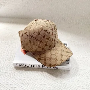Close-up of vintage jacquard baseball cap with rhinestones and monogram pattern