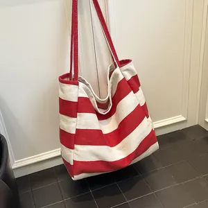 Grande borsa tote in tela a righe rosse e bianche con lunghe tracolle rosse per uso quotidiano