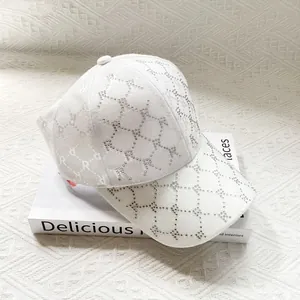 Detail of white baseball cap with rhinestone diamond patterns and jacquard letter R