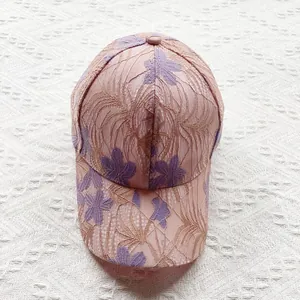 Detailed view of the delicate purple floral lace embroidery on breathable mesh sun hat