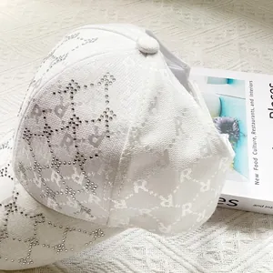 Detail of white jacquard sun hat with rhinestone stars and letter R monogram embroidery