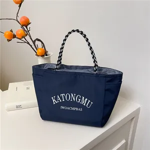 Minimalist navy blue large capacity tote bag with woven handles for daily commuting