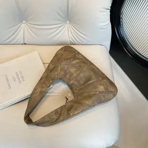 Minimalist vintage brown crescent shoulder bag in soft leather with unique stitching