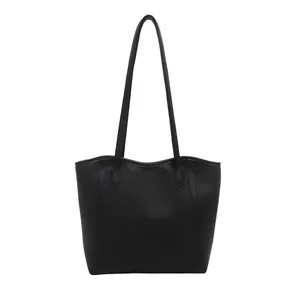 Minimalist black tote bag in smooth leather finish with large capacity for women