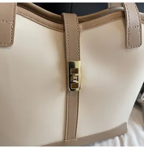 Close-up of golden swivel lock and contrast stitching on the minimalist tote bag
