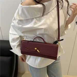 Chic dark red crocodile embossed baguette bag with gold hardware and shoulder strap