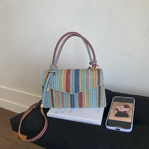 Colorful striped woven handbag with dual top handles and detachable shoulder strap