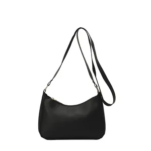 Minimalist black crescent shoulder bag in matte PU leather with gold metal hardware