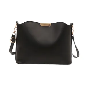 Minimalist black PU leather crossbody bag with wavy top and gold metal hardware detail