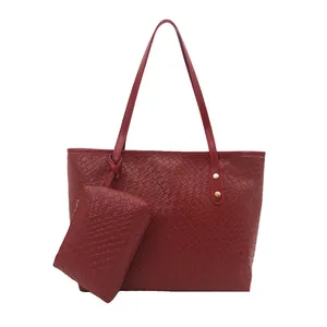 Large red woven tote bag set with matching pouch and gold rivet details for women