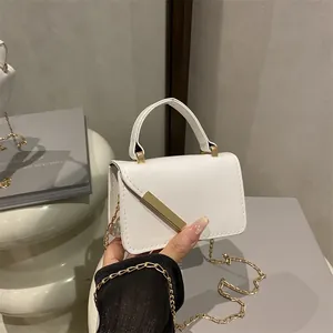 White mini PU leather handbag with gold metal clasp and chain strap for women