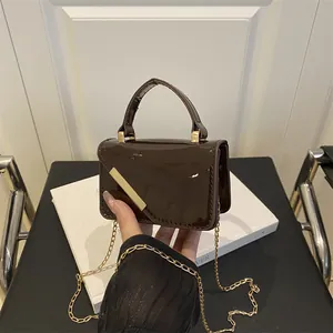 Mini dark brown patent leather crossbody bag with gold chain and top handle for women