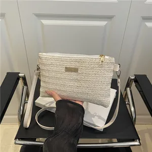 Minimalist white woven straw crossbody bag with golden logo plaque for women