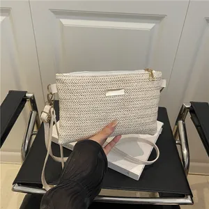 Beige woven crossbody bag with silver hardware and thin shoulder strap for women