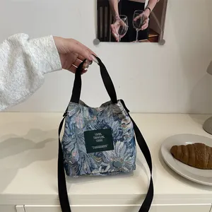 Retro floral jacquard bucket bag with versatile crossbody strap and woven top handles