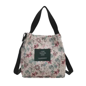 Floral canvas bucket bag with floral patterns and black straps for 2025 summer fashion