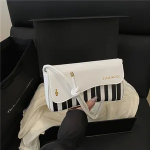 Elegant piano key pattern handbag for women with music notes and white leather finish