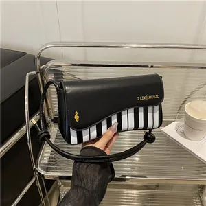 Retro piano pattern crossbody bag for women with gold music note buckle and strap