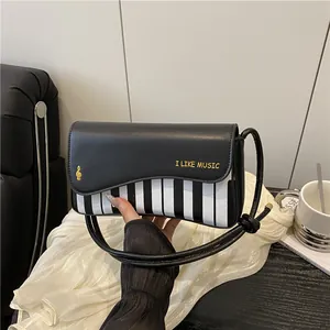 Piano themed crossbody bag with piano key pattern and I LIKE MUSIC print on cover