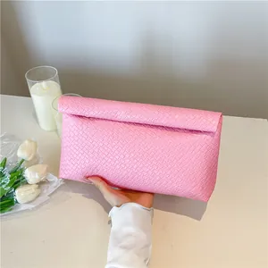 Pink woven texture clutch bag for women with elegant folded top design for party fashion