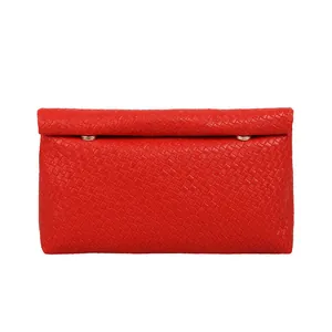 Bright red woven clutch bag with minimalist rectangular design and gold metal buckles