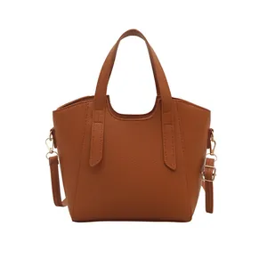 Brown lychee pattern leather tote bag with gold hardware and adjustable strap