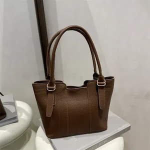 Deep brown litchi pattern leather tote bag with light gold hardware for daily commute