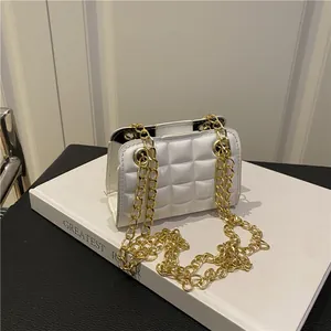 Ivory quilted crossbody bag with gold chain strap on a minimalist studio background