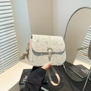 Woven straw crossbody bag with floral embroidery and gold metal lock for summer fashion
