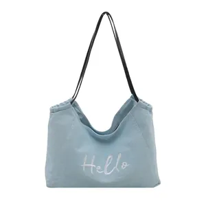 Sac fourre-tout en toile bleu clair minimaliste avec broderie Hello et anses noires fines
