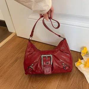 Retro red faux leather shoulder bag with metallic buckle details and wrinkled texture