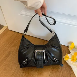 Retro black distressed crescent shoulder bag with large silver buckle and Y2K aesthetic