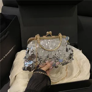 Sparkly silver sequin evening clutch bag with gold chain and handle in a gift box