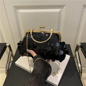 Sparkly black sequin evening clutch bag with gold metal handle and chain strap
