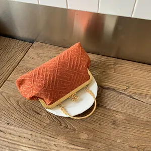 Retro brick red woven shell clutch bag with gold ring handle and metal clasp