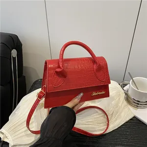 Elegant red faux crocodile texture crossbody bag with gold logo and top handle for women