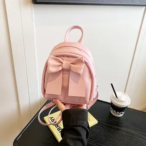 Mini sac à dos en cuir rose pour femme avec un grand nœud décoratif et une poignée