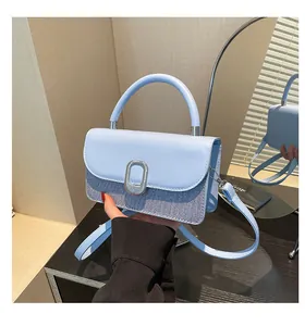 Detail showing high-quality light blue PU leather and denim stitching with metal buckle
