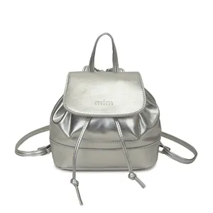 Minimalist silver metallic mini backpack for women featuring drawstring and flap design
