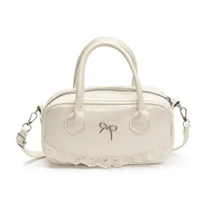 Cream white Boston bag with silver bow accent and delicate lace trim for women