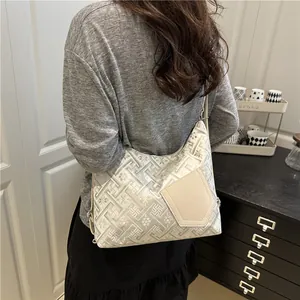 Hobo style jacquard shoulder bag with geometric patterns and leather pocket accent