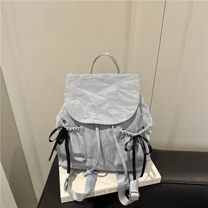 Light blue bow backpack with Nilka embroidery and black ribbon details in Japanese style